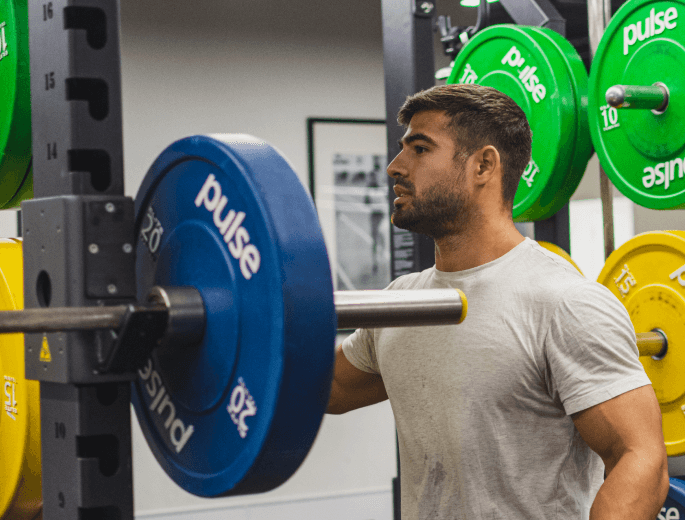 A gym user checks in at the gym reception using the Hussle mobile app