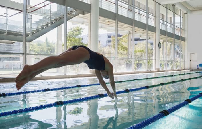 Person diving into a swimming pool