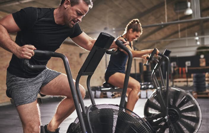 People in a gym on exercise bikes