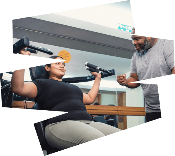 A person using a shoulder press machine in a gym while another person encourages them
