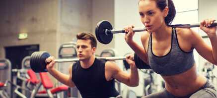 People in a gym exercising with weights